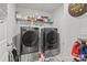Laundry room features new washer and dryer, shelf with laundry products and gray flooring at 7172 Indigo Way, Denver, NC 28037
