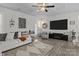 Bright living room featuring a comfortable sofa, stylish decor, and a large-screen television at 7172 Indigo Way, Denver, NC 28037