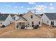 Back of the house featuring a covered patio and landscaped backyard at 7172 Indigo Way, Denver, NC 28037