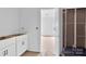 Bathroom featuring white cabinets, a door, and unfinished walls, showcasing modern design at 8455 W Nc 152 Hwy, Mooresville, NC 28115