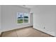 Bright bedroom showcases a large window offering natural light and scenic outdoor views, ready for personalization at 8455 W Nc 152 Hwy, Mooresville, NC 28115