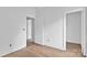 Bright bedroom with fresh white walls, awaiting personal touches and decor; a door to the left leads to another room at 8455 W Nc 152 Hwy, Mooresville, NC 28115