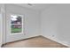 Bright room with a large window showcasing a green outdoor view, with fresh white walls awaiting personal touches at 8455 W Nc 152 Hwy, Mooresville, NC 28115
