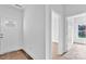 Bright entryway featuring white walls, doors, and trim, with newly installed hardwood flooring peeking from beneath protective paper at 8455 W Nc 152 Hwy, Mooresville, NC 28115