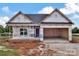 New construction home showing garage and covered entrance with gray roof and house wrap at 8455 W Nc 152 Hwy, Mooresville, NC 28115