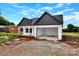 Exterior view of a new home with an open garage and white and black accents at 8455 W Nc 152 Hwy, Mooresville, NC 28115