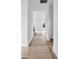 Bright hallway with white walls and trim, newly installed hardwood floors, and natural light streaming in from a window at 8455 W Nc 152 Hwy, Mooresville, NC 28115