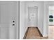 Bright hallway featuring white walls, a door to the exterior, and modern trim work at 8455 W Nc 152 Hwy, Mooresville, NC 28115