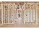 Interior framing and utilities installation, with visible doorway and a partial view to the yard at 8455 W Nc 152 Hwy, Mooresville, NC 28115