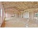 Partially insulated room with framing, exposed utilities, door, and window views to exterior at 8455 W Nc 152 Hwy, Mooresville, NC 28115