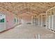 Open layout room with insulation, framing, door, and views from windows to the outdoor landscape at 8455 W Nc 152 Hwy, Mooresville, NC 28115