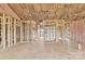 Expansive living area being built with wooden framework, pink insulation, and a modern white water heater at 8455 W Nc 152 Hwy, Mooresville, NC 28115