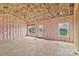 Exposed framework and insulation in a new living room with windows showing scenic exterior views at 8455 W Nc 152 Hwy, Mooresville, NC 28115