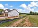 Side view of a new home under construction showing a vast lot with a serene pasture backdrop at 8455 W Nc 152 Hwy, Mooresville, NC 28115