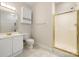 Bright bathroom featuring a glass shower, single sink vanity and tile floors at 8617 Coralbell Ln, Charlotte, NC 28213