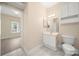 Neutrally decorated bathroom with a single sink vanity and ceramic tile flooring at 8617 Coralbell Ln, Charlotte, NC 28213