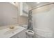 Bathroom featuring a single sink vanity, ceramic tile flooring and shower-tub combination at 8617 Coralbell Ln, Charlotte, NC 28213