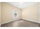 Bright bedroom with large window, light-colored walls, and wood-look flooring at 8617 Coralbell Ln, Charlotte, NC 28213