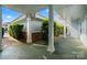Covered walkway with manicured bushes and supporting columns of residential building at 8617 Coralbell Ln, Charlotte, NC 28213