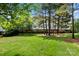 Apartment complex with beautiful green lawns and mature trees providing ample shade at 8617 Coralbell Ln, Charlotte, NC 28213