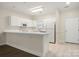 Kitchen featuring white cabinetry, tiled floor, and a breakfast bar for seating at 8617 Coralbell Ln, Charlotte, NC 28213