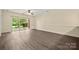 Spacious living room with sliding glass doors to the outside and hardwood floors at 8617 Coralbell Ln, Charlotte, NC 28213