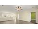Open-concept living room with hardwood floors, neutral walls, and modern ceiling fan at 8617 Coralbell Ln, Charlotte, NC 28213