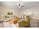 Inviting living space with a cozy sofa, chairs, and a view into the dining area and kitchen at 8617 Coralbell Ln, Charlotte, NC 28213