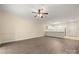 Spacious open-concept living area with light-colored walls, and easy access to the kitchen and front door at 8617 Coralbell Ln, Charlotte, NC 28213