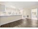 Open concept floor plan with kitchen and living room, hardwood floors, and neutral paint at 8617 Coralbell Ln, Charlotte, NC 28213