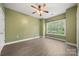 Bright bedroom featuring a large window, closet, and ensuite bathroom at 8617 Coralbell Ln, Charlotte, NC 28213