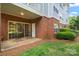 Charming brick patio with glass sliding doors and outdoor seating, leading to a small yard at 8617 Coralbell Ln, Charlotte, NC 28213