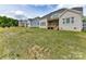 Back of the house featuring a lawn and stairs leading to a covered porch at 873 Penny Royal Ave, Fort Mill, SC 29715