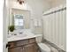 Bright bathroom with a vanity, framed mirror, updated fixtures, and shower-tub combo at 873 Penny Royal Ave, Fort Mill, SC 29715