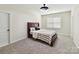 Comfortable bedroom with neutral walls, carpet, window, and a dark wood frame bed at 873 Penny Royal Ave, Fort Mill, SC 29715