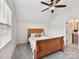 Bedroom showcasing a wooden bed frame, neutral carpet, ceiling fan, and natural light at 873 Penny Royal Ave, Fort Mill, SC 29715