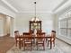 Elegant dining room with hardwood floors, a chandelier, and a large window at 873 Penny Royal Ave, Fort Mill, SC 29715