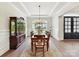 Formal dining room featuring wood floors, wainscoting, and a large window offering ample natural light at 873 Penny Royal Ave, Fort Mill, SC 29715
