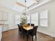 Dining area with wood floors, modern light fixture, and large windows for ample natural light at 873 Penny Royal Ave, Fort Mill, SC 29715