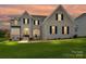 Charming two-story home with white brick, black shutters, and a well-manicured front lawn at 873 Penny Royal Ave, Fort Mill, SC 29715