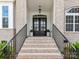 Elegant entryway featuring a dark double door, brick steps, and black iron railings at 873 Penny Royal Ave, Fort Mill, SC 29715