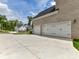 Attached two car garage with white doors and a wide concrete driveway at 873 Penny Royal Ave, Fort Mill, SC 29715
