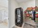 Bright laundry room with stacked washer and dryer, storage shelves and easy access to an adjacent bathroom at 873 Penny Royal Ave, Fort Mill, SC 29715