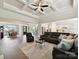 Spacious living room with hardwood floors, a coffered ceiling, and an open layout to the kitchen and dining area at 873 Penny Royal Ave, Fort Mill, SC 29715