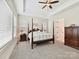 Main bedroom featuring carpet, a tray ceiling, and large windows offering plenty of natural light at 873 Penny Royal Ave, Fort Mill, SC 29715