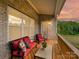 Covered back porch with brick wall, wood flooring, and outdoor furniture at 873 Penny Royal Ave, Fort Mill, SC 29715