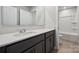 Modern bathroom showcasing a sleek vanity with quartz countertop and a shower-tub combo at 9940 Manor Vista Trl, Kannapolis, NC 28027