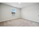 A sunny bedroom with neutral carpet and window views at 9940 Manor Vista Trl, Kannapolis, NC 28027