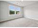 Carpeted bedroom with double windows offering views of the yard at 9940 Manor Vista Trl, Kannapolis, NC 28027
