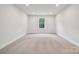 This bedroom has plush carpeting and a window looking out on the trees at 9940 Manor Vista Trl, Kannapolis, NC 28027